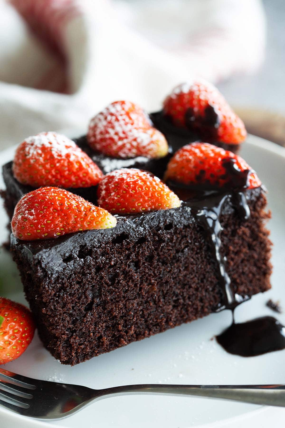 Chocolate cake that is homemade, simple, moist and topped with strawberries.