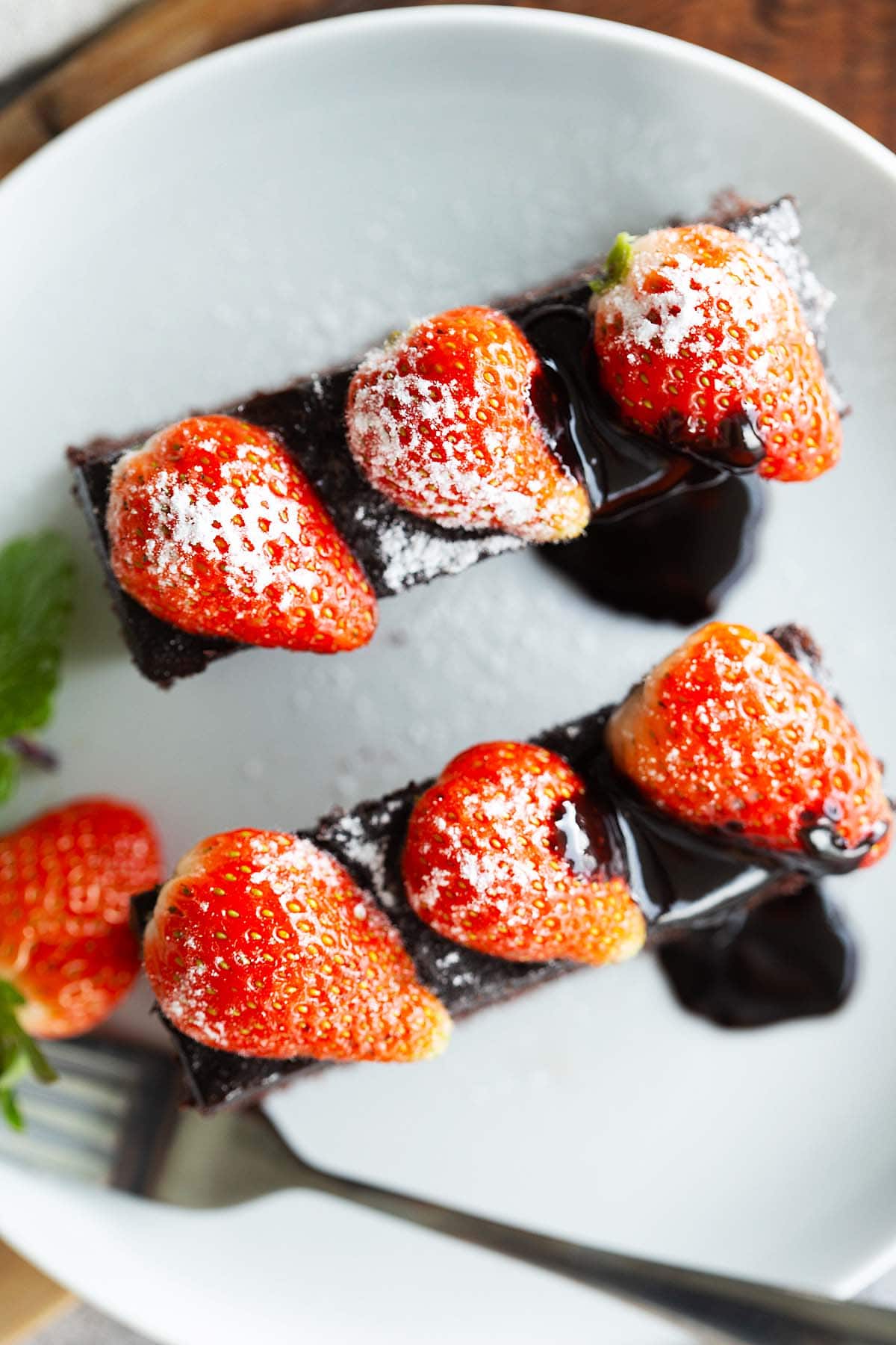 Top down shot of delicious chocolate cake with strawberries on top. 
