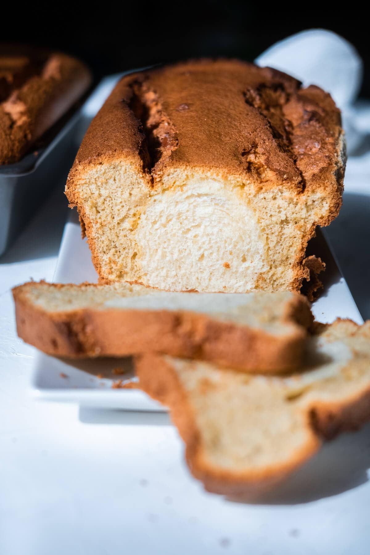 Front view of a slice of sweet bread coated with aromatic coffee cake cut from a loaf of bread. 