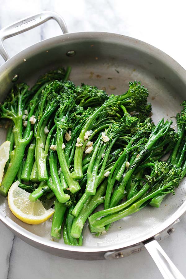 Broccolini sauteed with garlic butter cooked in a pan.
