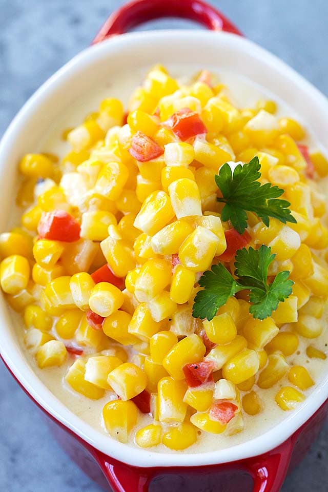 Easy and quick creamed Corn garnished with parsley, in a creamy sauce.
