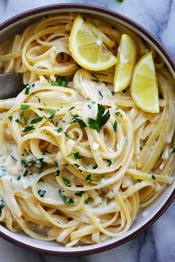 Pasta in Instant Pot with creamy sauce and chopped parsley.
