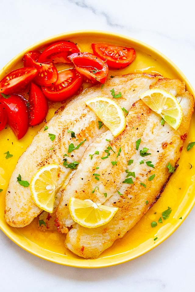 Swai fish with lemon butter sauce on a plate, ready to serve.