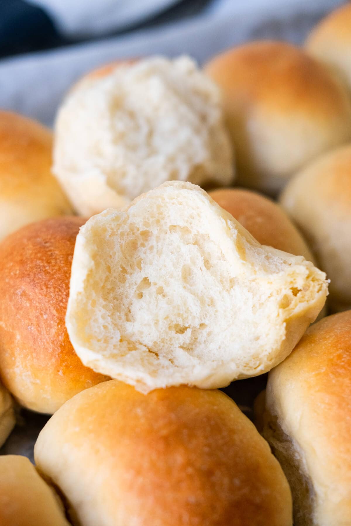 A half cut opened round bun with fluffy white soft on the interior and golden brown exterior.